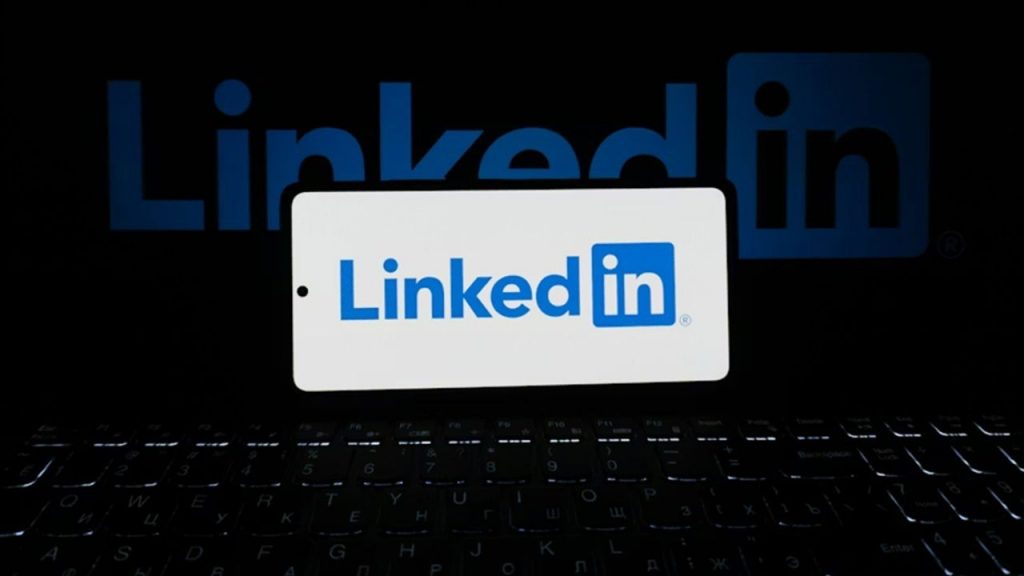 Phishing Comments Invading LinkedIn: Here’s What to Watch For Linkedin a laptop and a phone.