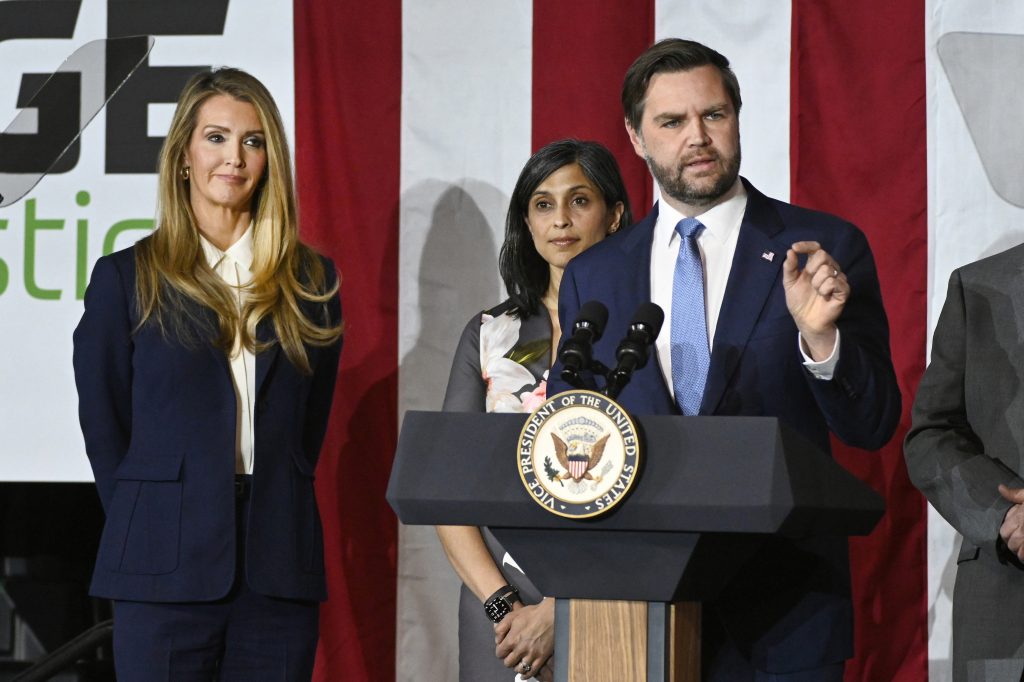 Vice President JD Vance, right, speaks at a rally about "America's industrial resurgence," as he is flanked by Administrator of the Small Business Administration Kelly Loeffler, far left, and his wife, Usha Vance, Friday, March 14, 2025, at Vantage Plastics in Bay City, Mich. (AP Photo/Jose Juarez)