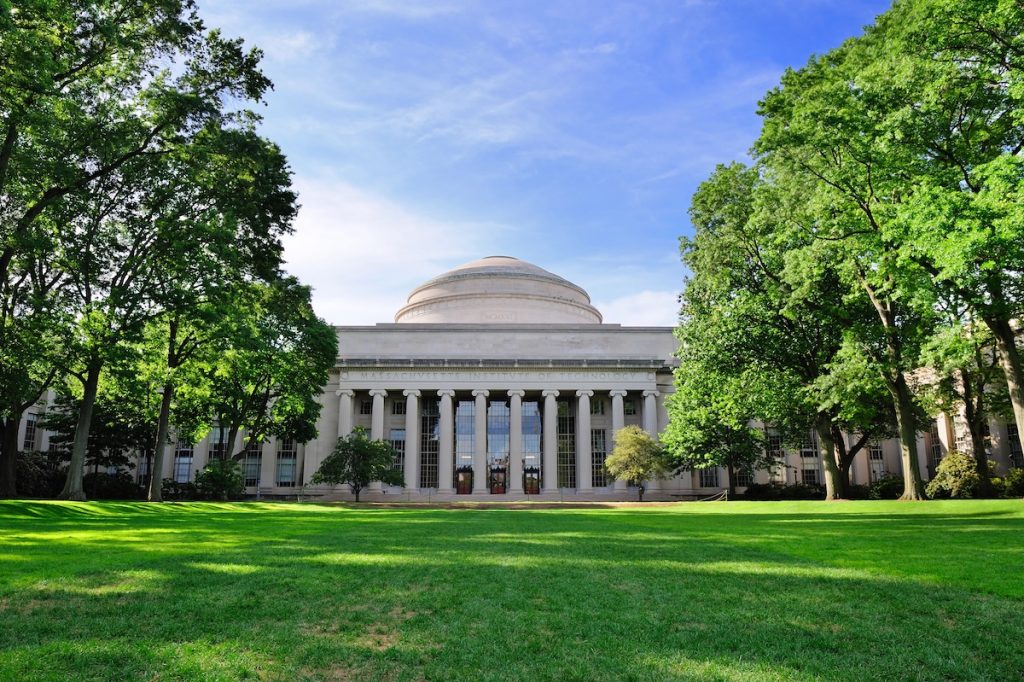 MIT To Admit Fewer Graduate Students As Federal Research Funding Drops 20% Boston Massachusetts Institute of Technology campus with trees and lawn