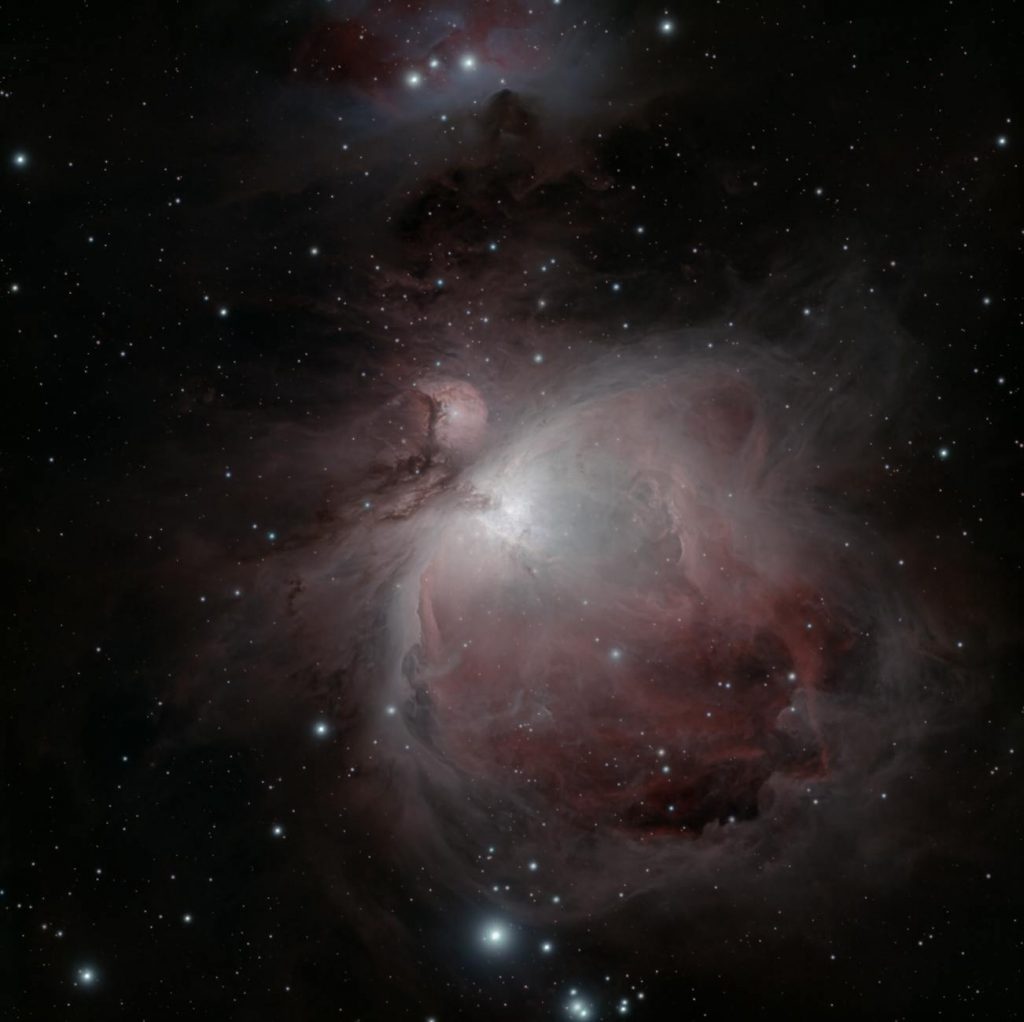 Stunning capture of the Orion Nebula (M42) with sparkling stars and vibrant emission clouds.