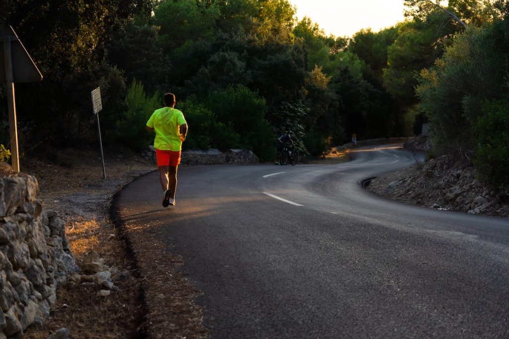 Young man running down the road without limits, representing the upcoming graduate loan limits. Source: The College Investor