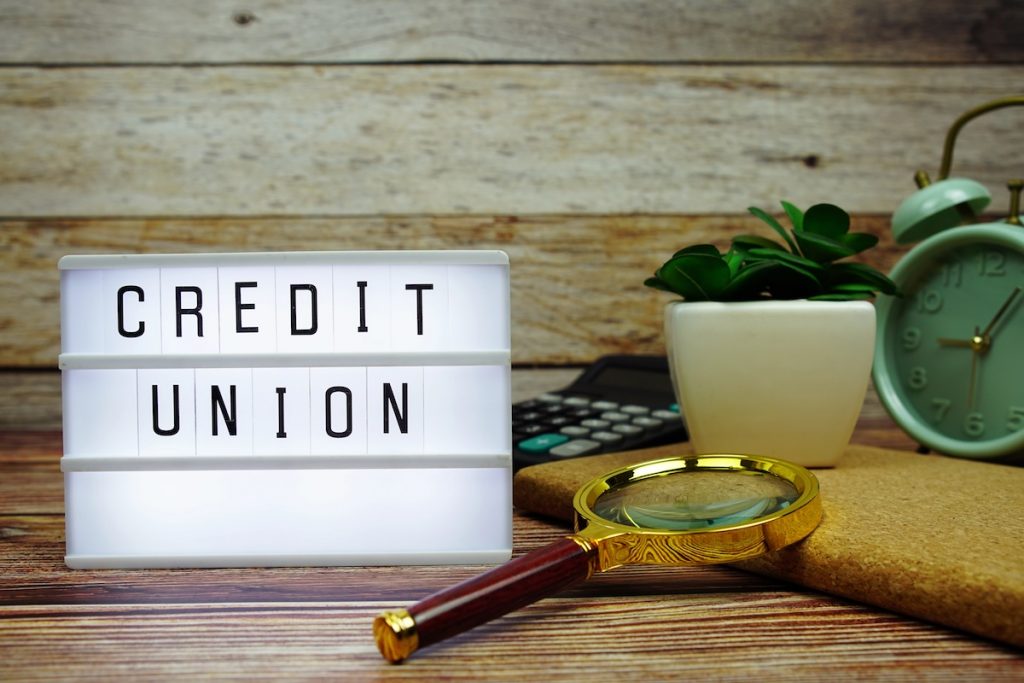 Why a Credit Union Might Be the Smartest Place to Get a Student Loan CREDIT UNION letterboard text on LED Lightbox on wooden background. Source: The College Investor