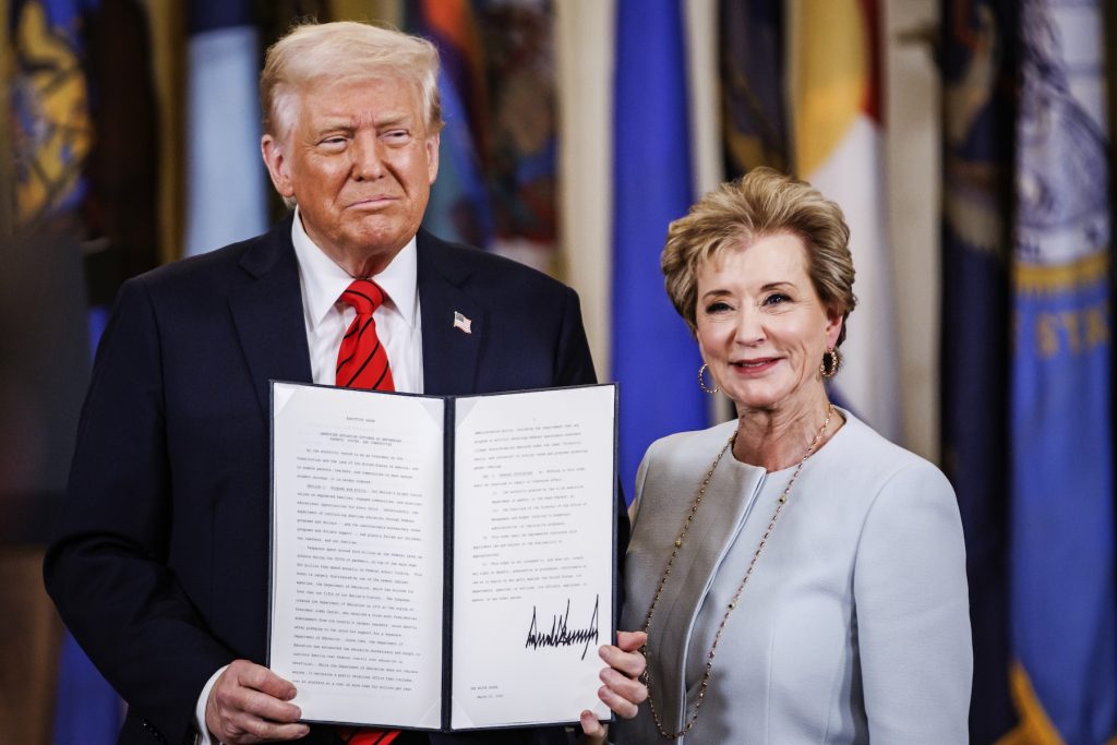 What PSLF Borrowers Need To Know About Green Banners President Donald Trump and Education Secretary Linda McMahon stand side-by-side in a formal setting backed by flags, holding open a leather-bound folder to display a signed document. This official ceremony serves as a visual metaphor for the "golden letter"—the formal notice of discharge that Public Service Loan Forgiveness (PSLF) borrowers anxiously await to confirm their loans are forgiven after reaching the 120-payment milestone marked by the "green banner." (Photo by Samuel Corum/Sipa USA)(Sipa via AP Images)